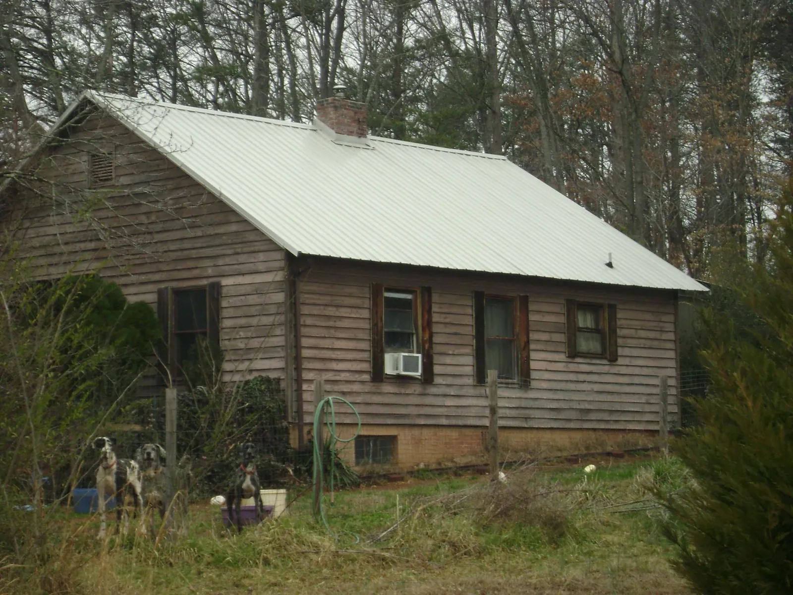 White metal roof on an old wood sided farmhouse, from a Asphalt Shingle Roof Repair job in Universal City